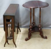 A mahogany trefoil-shaped table with three supports, carved detail and undershelf raised on