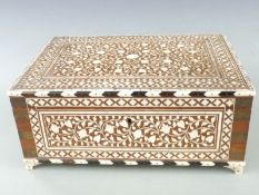 A 19thC/20thC Indian inlaid bone Vizagapatam dressing table box with fitted interior, raised on