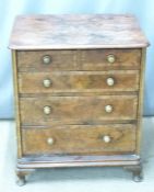 A 19thC crossbanded walnut bachelor's chest of two over three graduated drawers, raised on