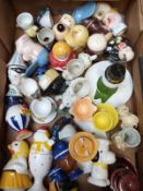 Approximately 30 novelty egg cups including figural, retro, kitsch, Japanese etc