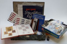 A box file and two tins of loose stamps in packets, Hungary stock book, blocks of mint GB 1st