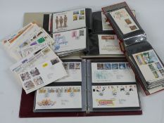 A large collection of GB, Channel Island and Isle of Man first day covers, loose and in four albums