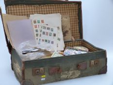 A suitcase of all-world stamps, loose and on sheets