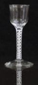 An 18thC drinking glass with white double twist stem and ogee shaped bowl raised on conical foot,