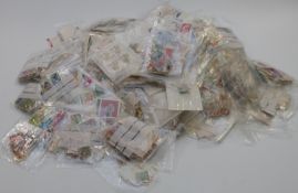 A substantial quantity of Commonwealth and foreign stamps in plastic bags together with four penny