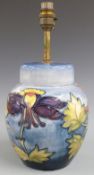 Moorcroft table lamp decorated in the Orchid pattern on a pale blue ground, H34cm