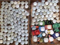 Approximately 140 novelty egg cups, mainly crested, and a small quantity of transport related