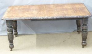 19thC oak wind-out extending dining table with carved edge and legs and two extra leaves, labels