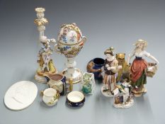 A collection of continental and majolica ceramics including a Dresden pedestal covered cup, figures,