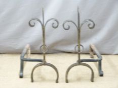 A pair of hand forged fleur de lys fire dogs, H 53cm