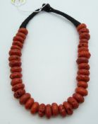 A Tibetan faux coral glass necklace