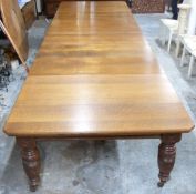 A large oak wind out extending dining table with six leaves, raised on five turned legs, W484 x D144
