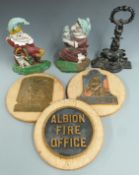 Three cast iron door stops including Mr Punch and three replica fire marks