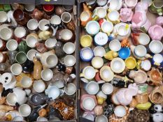Two trays of novelty ceramic egg cups, mostly animal / bird related, some by Quail