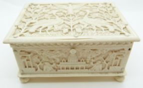 A late 19thC / early 20thC Chinese carved ivory box depicting birds, and men with tools, raised on