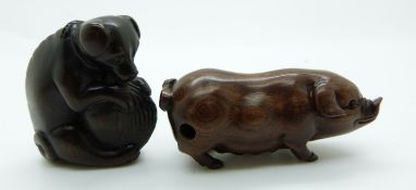 Japanese netsuke depicting a dog holding a shell between its legs, together with a vintage