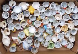 Approximately 60 novelty egg cups including figural, retro, kitsch, Japanese etc