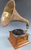 Horn gramophone with brass horn and Gilbert and Sullivan 78rpm records in a folder