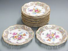 A set of twelve pierced Dresden cabinet plates hand decorated with flowers, diameter 23.5cm