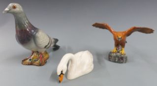 Three Beswick birds comprising pigeon, swan and small golden eagle, tallest 14cm