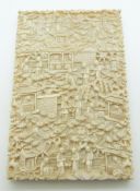 A 19thC Chinese carved ivory card case decorated with court / village scenes, 11.8 x 7.6cm