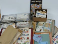 A collection of all world stamps in two boxes including first day covers, albums, loose stamps etc
