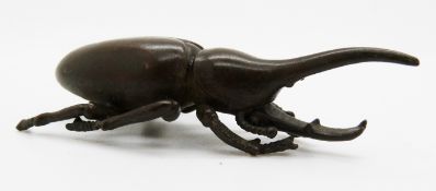 Japanese bronze of a rhinoceros beetle with mark to base, 8 x 3.2cm