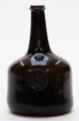 An early 18thC green glass mallet shaped wine bottle with seal 'H.Sanders Waterslad 1738', 21cm tall