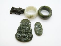 Two jadeite archer's rings, two jadeite pendants and a small jadeite carving