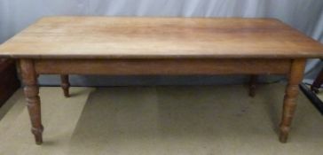 A mahogany farmhouse plank top dining table with two drawers raised on turned ash legs, W230 x