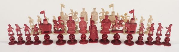 A 19thC/early 20thC Chinese carved ivory part puzzle ball chess set, one side stained red, height of
