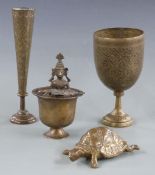 Four Eastern metal items including an unusual vessel featuring a figure carrying another figure