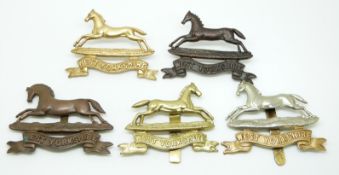Five British Army West Yorkshire Regiment metal cap badges