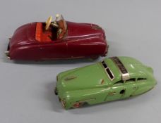 Two Schuco clockwork tinplate cars Tacho-Examico 4002 with maroon body and red interior and hubs and