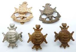 Five British Army Cinque Ports metal hat badges including a bronze example