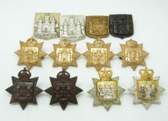 Twelve British Army East Surrey Regiment metal collar badges in four pairs plus four including