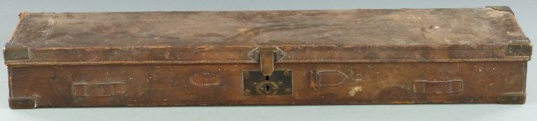 Brown leather and brass bound shotgun case with fitted interior, 82x23x9.5cm.