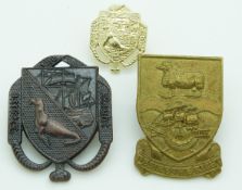 Three British Army Falkland Island badges in bronze, brass and anodised