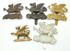 Five British Army The Buffs Royal East Kent Regiment metal cap badges including a Lambourne & Co