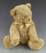 A vintage straw filled blonde mohair Teddy bear with shaved snout and pads and disc joints, 50cm