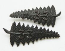 Two New Zealand Army WWI 33rd Reinforcements metal badges in the form of ferns