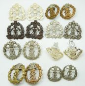 Sixteen British Army Middlesex Regiment metal badges in six pairs plus four including an officer's