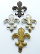 Four British Army Manchester Regiment metal hat badges including an officer's bronze example