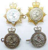 Four British Army Alderney Militia badges including an anodised example