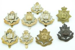 Nine British Army East Surrey Regiment metal cap badges, one by Buttons Ltd