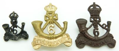 Three 6th King's African Rifles metal badges including an officer's service dress example