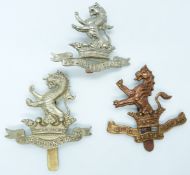 Three British Army 7th Dragoon Guards metal cap badges