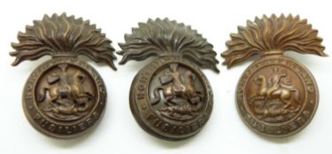 Two British Army Northumberland Fusiliers two piece cap or full size collar badges with flattened