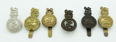 Six British Army Royal Devon Artillery Yeomanry metal cap badges