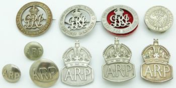 Three WWI silver war badges together with two hallmarked silver ARP badges etc